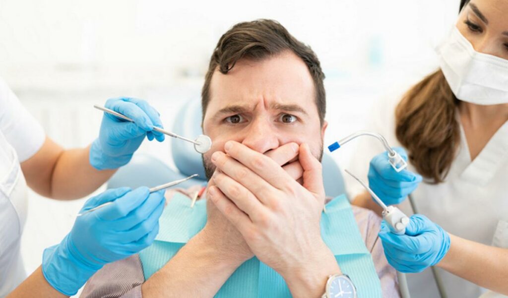 man scared during checkup at dental clinic